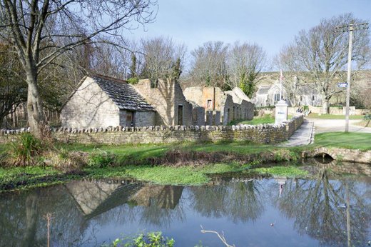 This shows the duck pond and ruined buildings of Tyneham village. There is a 1940s photo box and beyond the buildings is the Church which is not a ruin and can be visited  when the village is open to the public. 