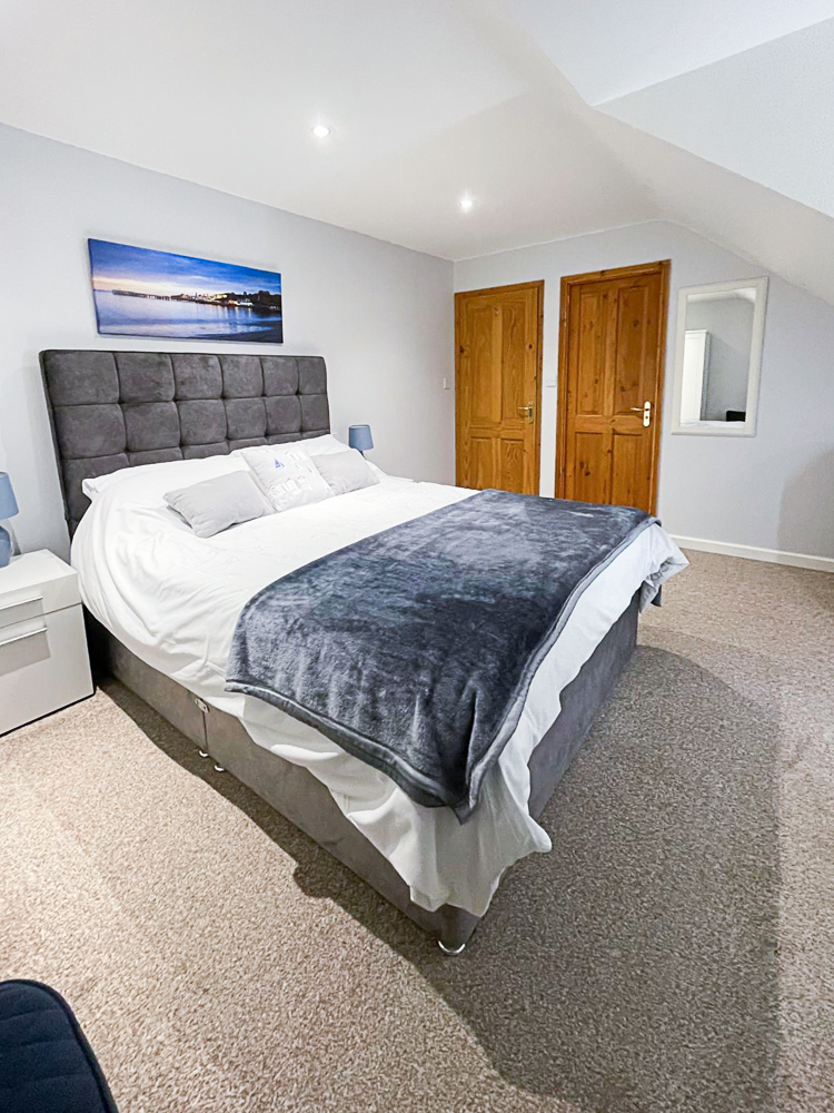 Betula House, master bedroom. Showing bed, cupboards and doorways to hall and en-suite bathroom. 