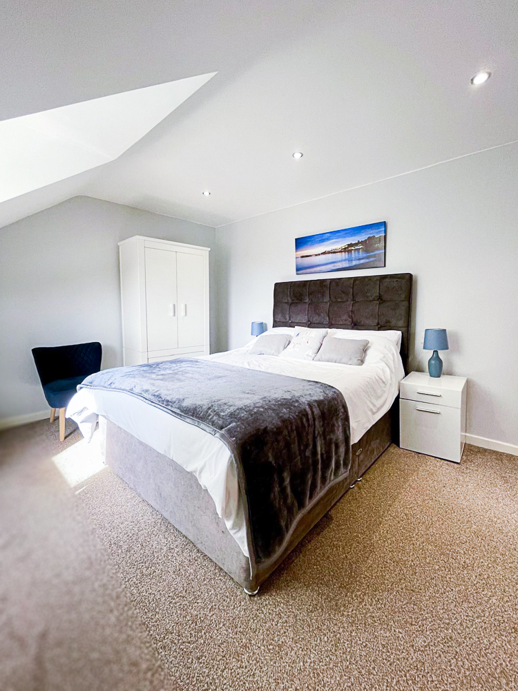 Betula House, master bedroom. Showing bed, cupboards and doorways to hall and en-suite bathroom. 